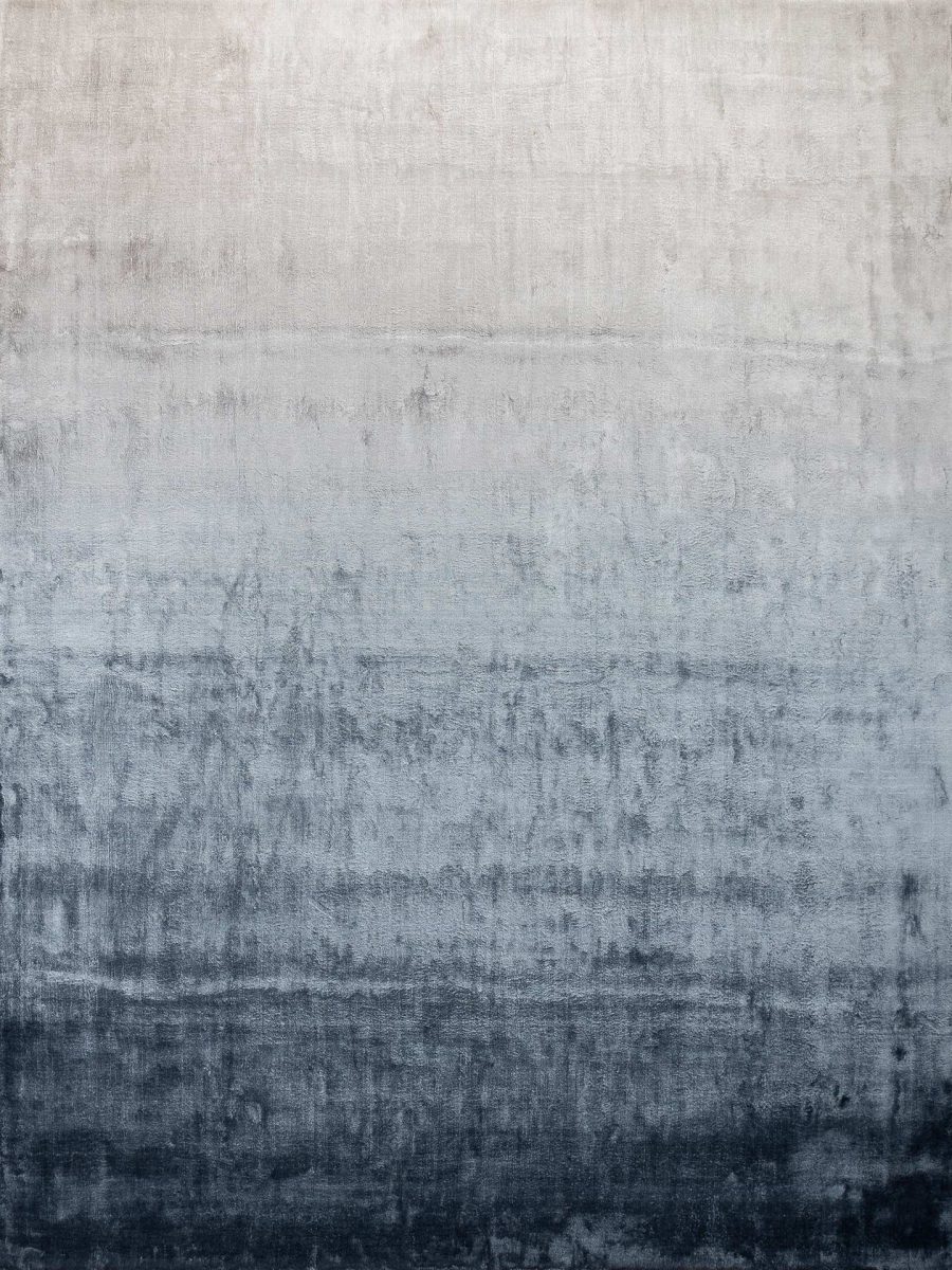 Texturierter Teppich mit abstrakter, verwaschener Grau- und Blautönen, ähnlich einer zerknitterten Stoffleinwand oder verwitterten Wand.